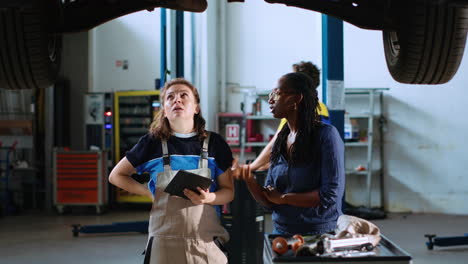 technician and woman look for car parts