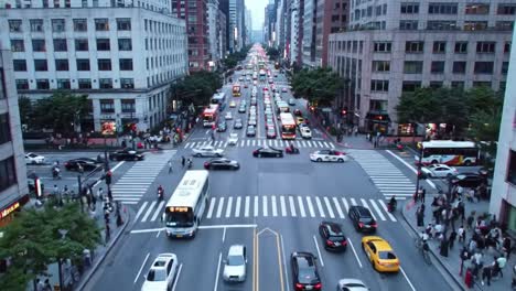 busy city street intersection with high-rise buildings in the background