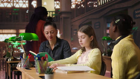 teacher assisting students in a library setting