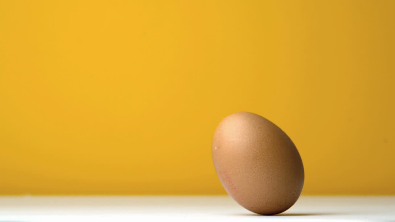 Egg revolving against yellow background