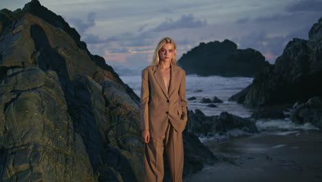 sexy girl posing evening beach in elegant suit with naked chest. fashion model