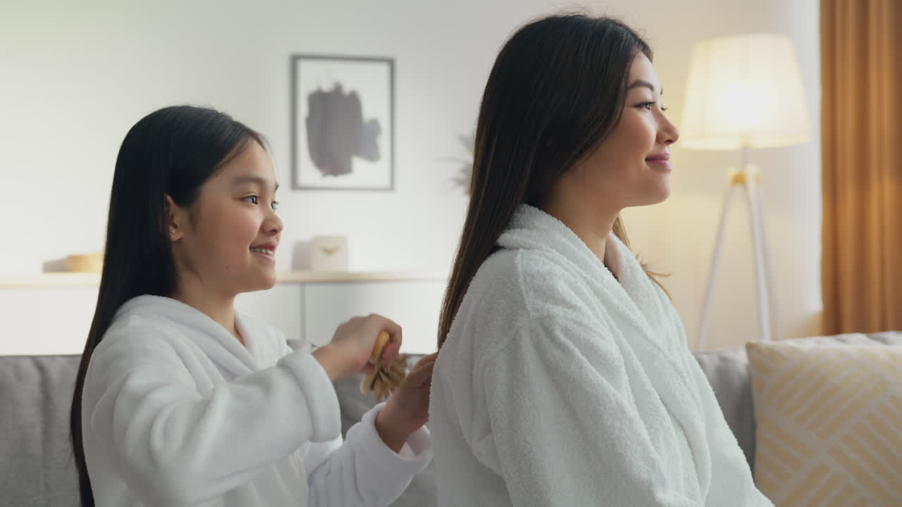 Daughter helps mother with hair
