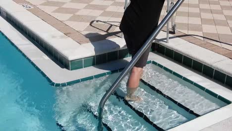 handicap man using his walker to get out of the pool