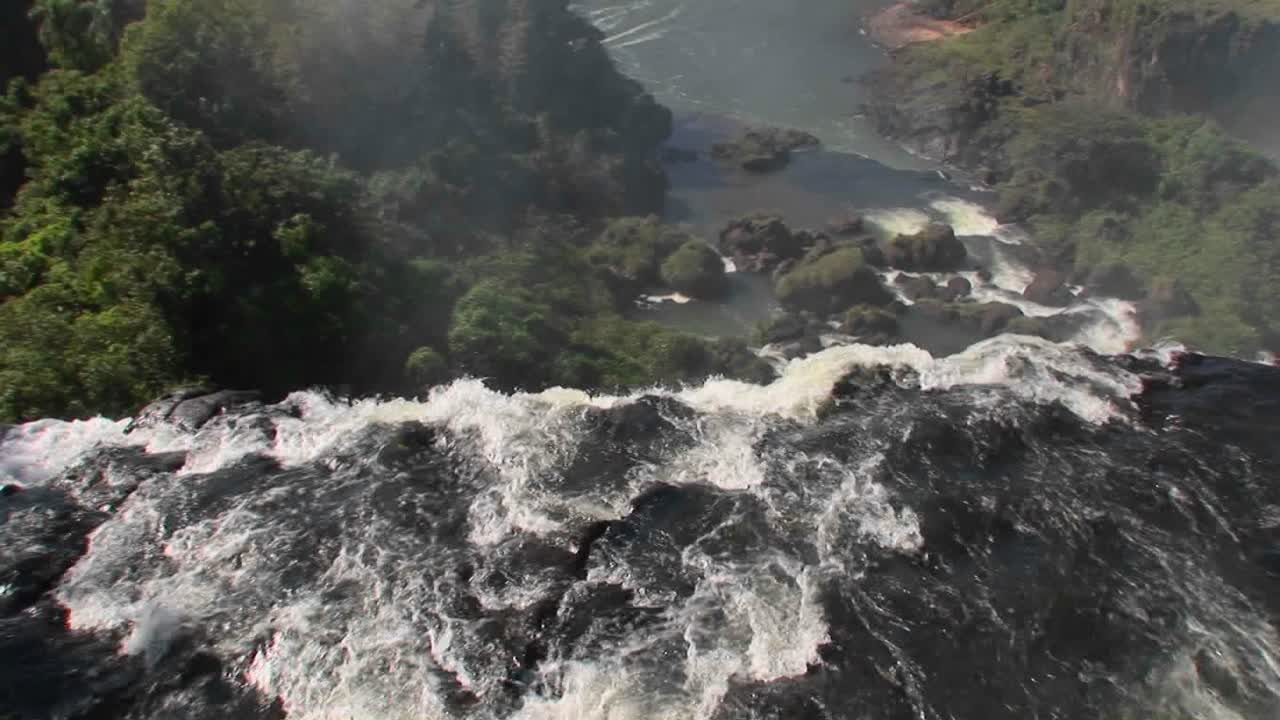 una perspectiva en movimiento mirando por encima del borde de una cascada cataratas de iguacu