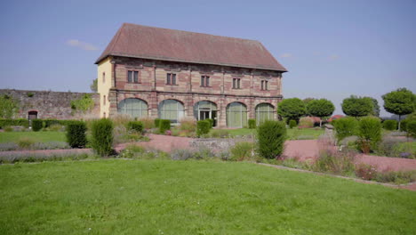 historic stone building with landscaped garden