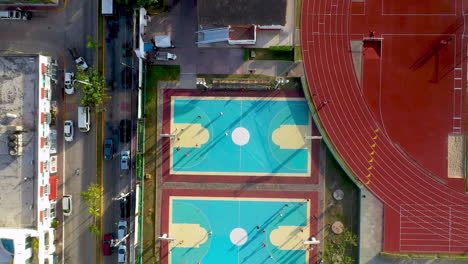 rising drone shot of basketball courts in the city of playa del carmen mexico