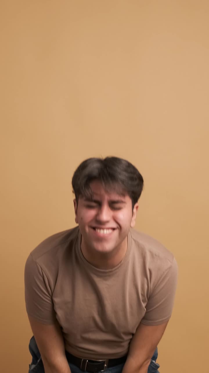 Casual young man jumping and dancing celebrating