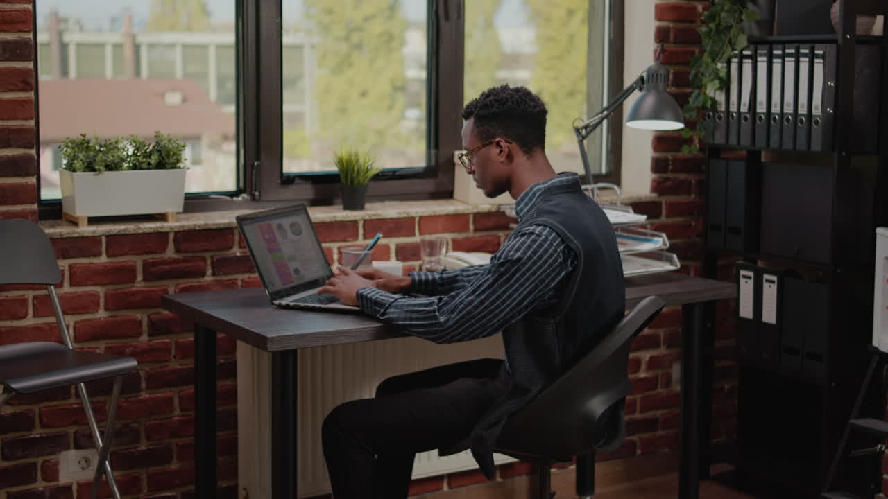 Financial consultant analyzing sales development on laptop