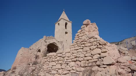 old buildings emerging from empty swamp due to the problems of extreme dryness and lack of rain