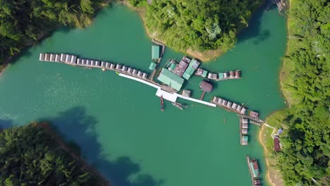 aerial drone view of the floating raft houses on the cheow lan lake at khao sok national park thailand