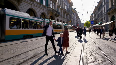 family walking on a city street with tram
