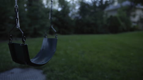 close up of a creepy swing at dusk being unused