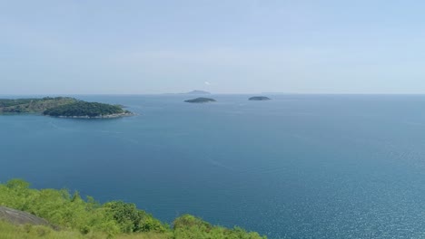 aerial view of tropical sea in phuket island.beautiful sea surface amazing waves seascape mountain view in phuket thailand.high quality footage from drone 4k