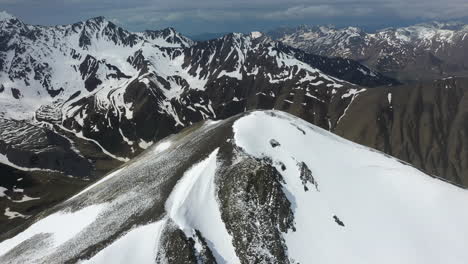 Rotating-drone-shot-of-the-snow-covered-Georgian-Dolomites-in-the-Caucasus-mountains-in-Georgia