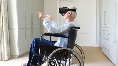 senior man on wheelchair using vr headset in bedroom