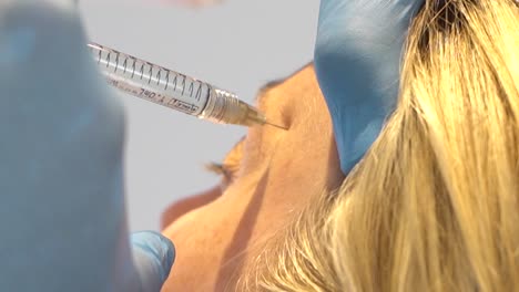 Closeup-of-cosmetologist-doctor-giving-a-woman-an-anti-aging-filler-injection