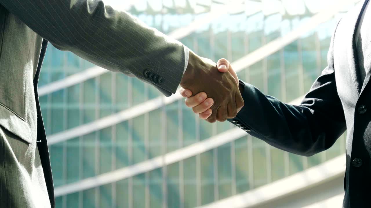 two industrial and marketing or financial people talk and shake hands to compete on a major project.