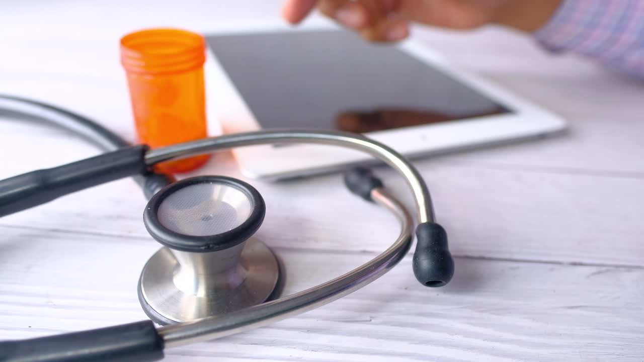 Doctor using tablet and stethoscope
