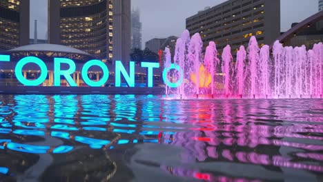 panning water fountain with an art installation in the background