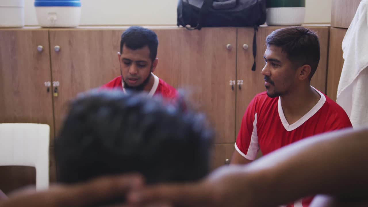 Soccer players discussing in the locker room