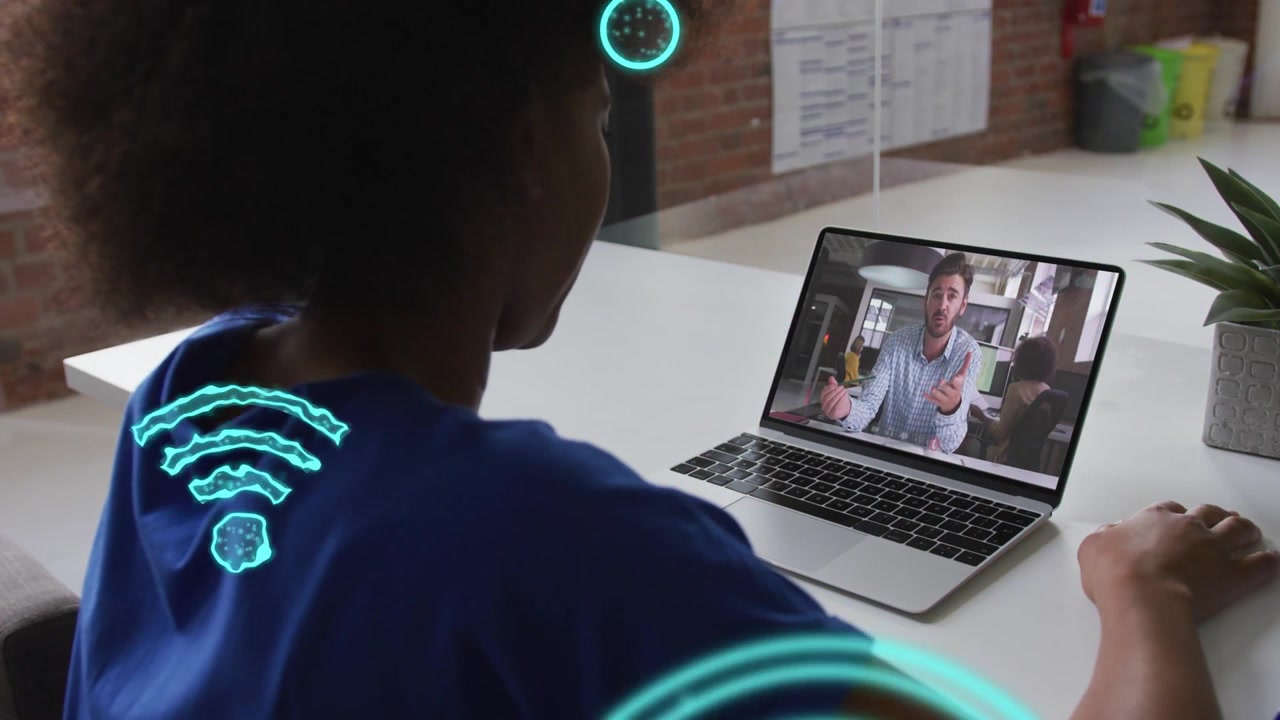 Woman watching laptop as speaker speaking, animating teal network icons around both for tech collab
