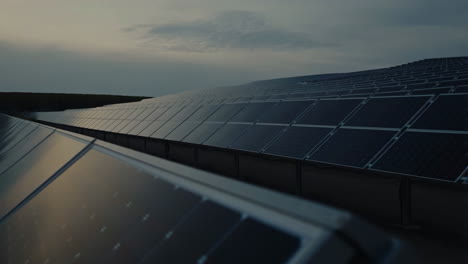 A vast solar farm generates clean energy under a cloudy sky