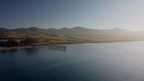 Cove-with-pier-and-mountain-landscape-in-background