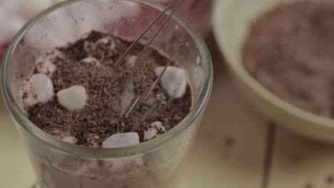 sprinkling and whisking chocolate sprinkles on luxury drink