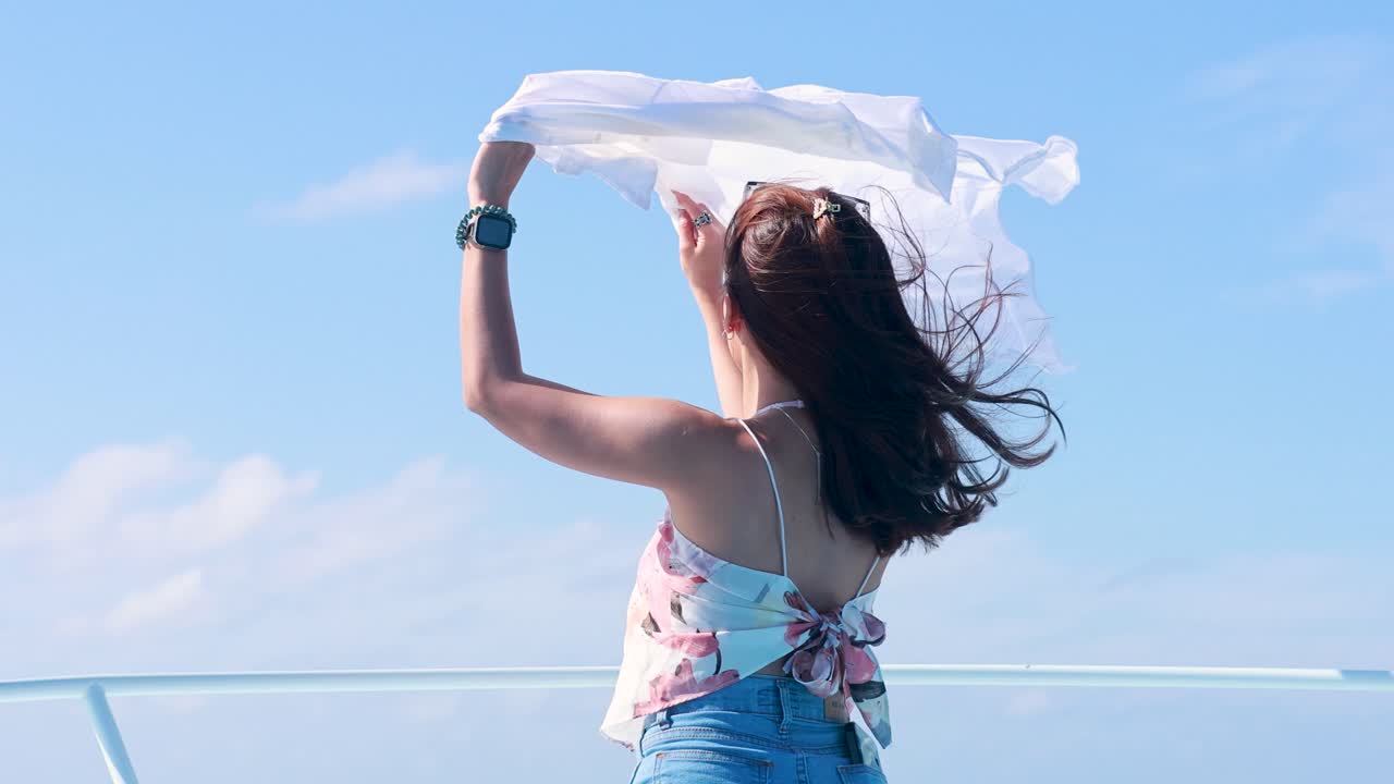 Woman enjoying the wind on a boat