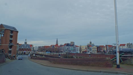 a-beautiful-and-lovely-view-of-european-city-town-streets-of-Netherlands-dutch-Holland-traditional-architecture-of-houses-and-buildings-with-road-and-car