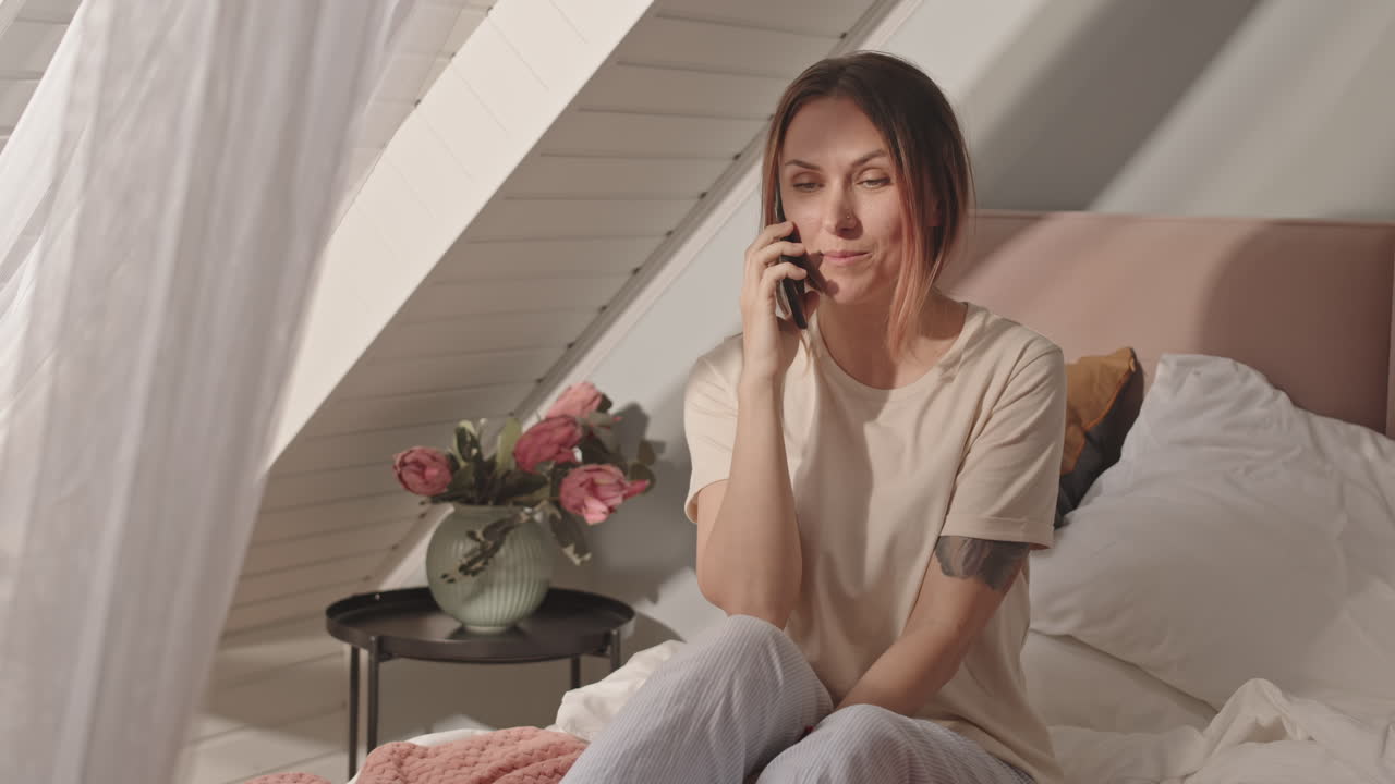 Woman Talking on Cellphone in Bed