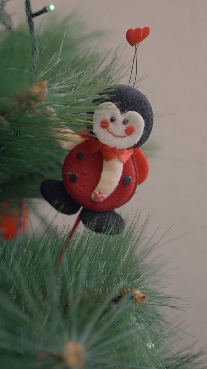 Decorating a Christmas Tree with a Ladybug Ornament