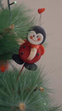 decorating a christmas tree with a ladybug ornament