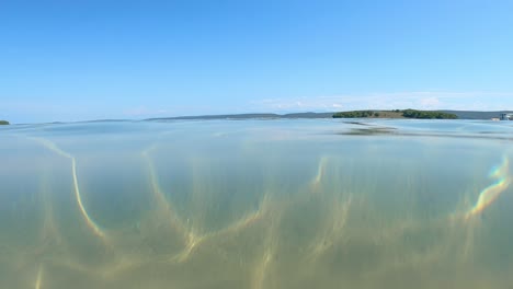 Slowly-Moving-Up-Above-Surface,-Beautiful-Clear-Turquoise-Water,-POV