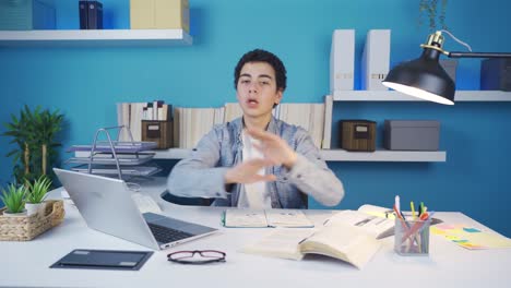 young man looking at camera giving negative expression with hand and facial expressions, making 'no', 'stop' signs.