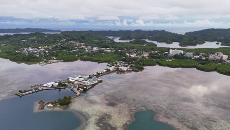 high-quality drone shot scanning and revealing the vivid aqua ocean and green-covered terrain in palau. circling drone shot of an island resort
