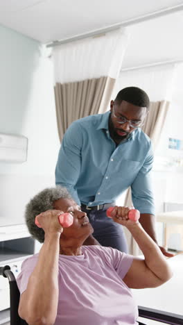 vertical video, senior african american woman, male doctor in hospital, slow motion, copy space