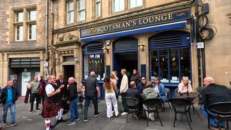 people socializing outside the scotsman's lounge