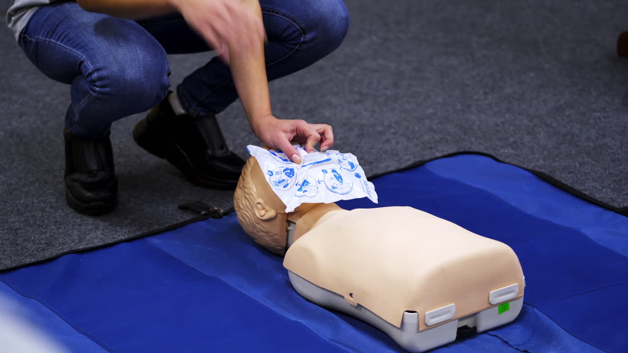First aid cardiopulmonary resuscitation course. Instructor demonstrating cardiopulmonary resuscitationon mannequin at first aid training course