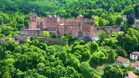4k aerial drone video of ruins of historic castle on königstuhl hill overlooking heidelberg, germany