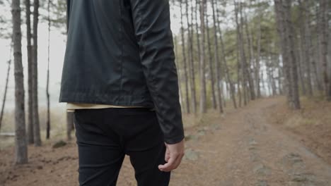 Man-walking-on-a-path-in-the-forest-in-the-Rhodope-mountain-region,-Bulgaria