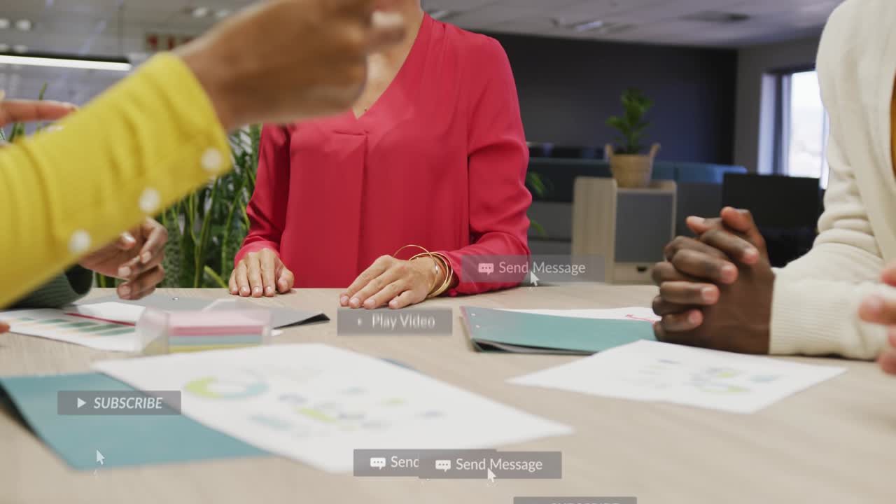 Gathering team around table in office, red-blouse leader placing hands over charts, alerts floating