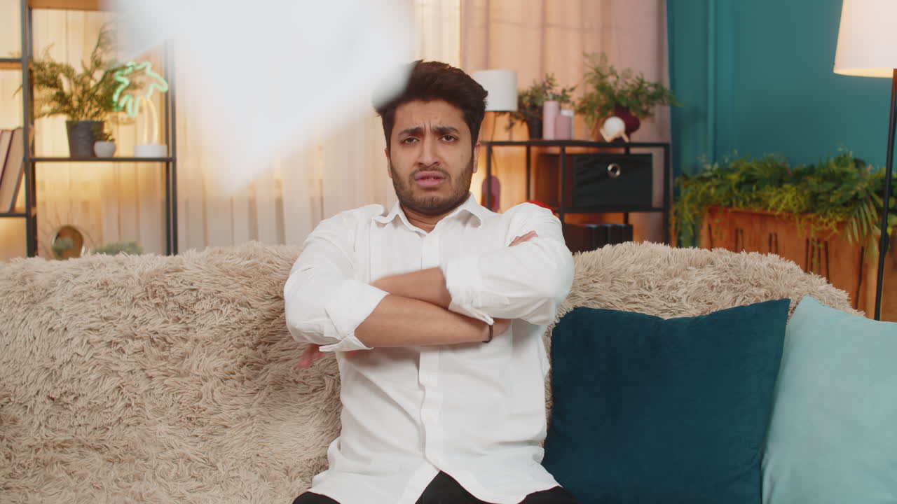 Indian young man shocked nervously checking and throwing bills financial stress debt report mistakes