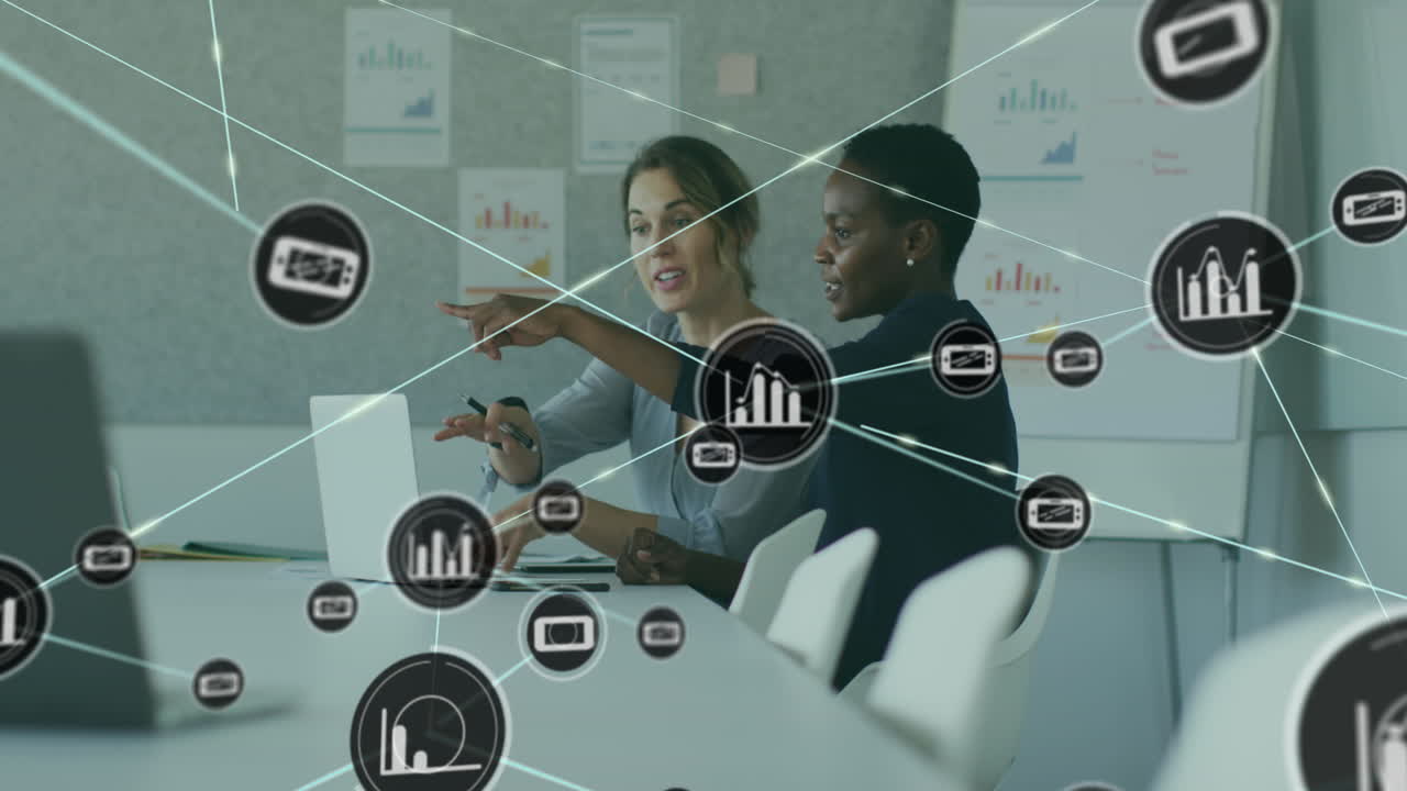 Animation of connected icons over diverse female coworkers discussing report on laptop at office