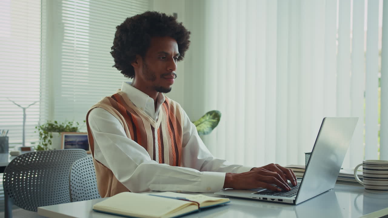 Solopreneur Smiling at Camera by Laptop at Office Desk