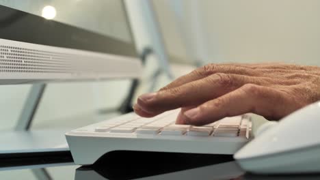 hands typing on computer keypad, office workspace, modern technology in company