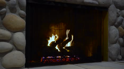 fire burns in a fireplace at night dark romantic still shot