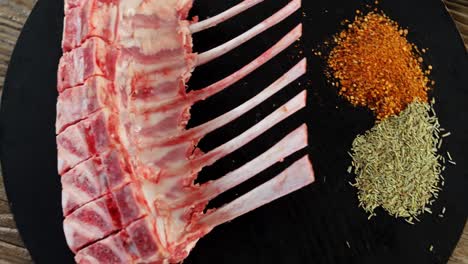 Raw-beef-ribs-and-ingredients-on-wooden-board