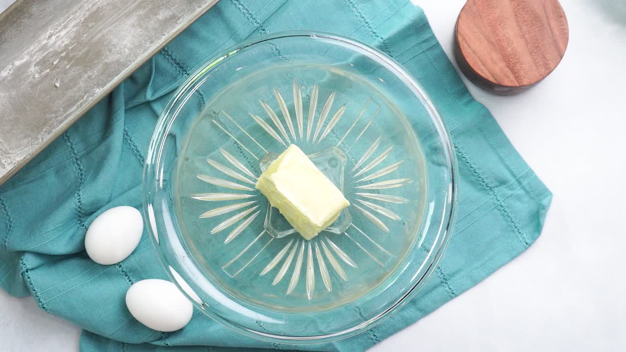 Making a dessert called Red Raspberry Tea Cake made with fresh berries and vanilla buttercream frosting. Great for Tea Parties. Adding sour white sugar to the mixing bowl and combining the ingredients