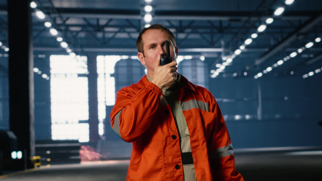 Technician using walkie talkie during job assignment in manufacturing facility